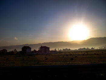 Scenic view of field against sky during sunset