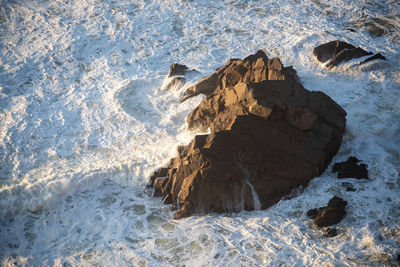 High angle view of rocks in sea