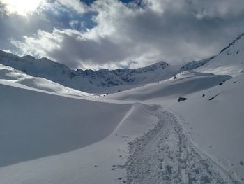 Scenic view of snowcapped mountains against sky