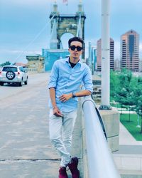 Young man wearing sunglasses in city