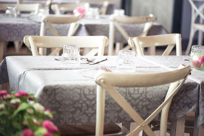 Tables and chairs arranged at shabby chic restaurant