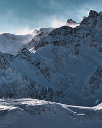 Scenic view of snowcapped mountains against sky