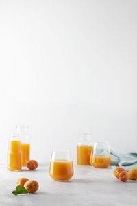 High angle view of juice in bottles against white background