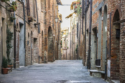 Narrow alley amidst buildings in city