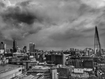 Cityscape against cloudy sky