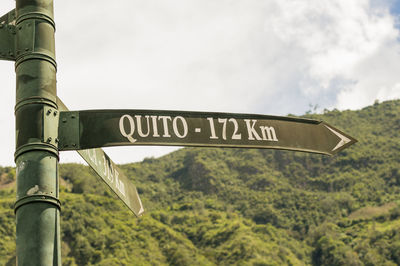 Low angle view of quito sign against sky