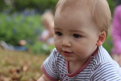 Close-up of cute baby boy looking away
