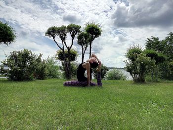Woman exercising on grass