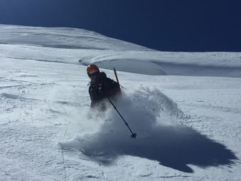 Person skiing on snowcapped mountain