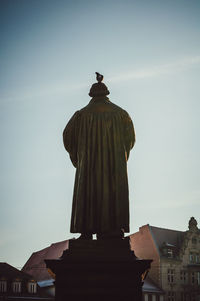 Low angle view of statue against sky in city