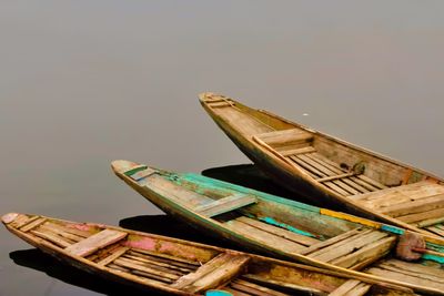 High angle view of old boat moored in water against sky