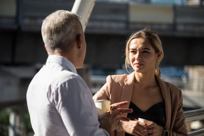 Man with woman standing outdoors