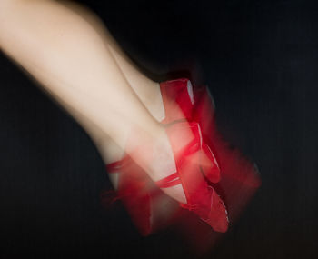 Close-up of human hand against black background