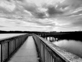 Pier over lake against sky