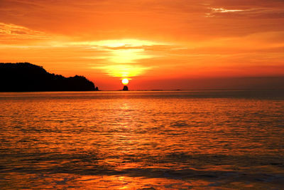 Scenic view of sea against romantic sky at sunset