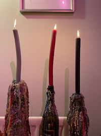 Close-up of lit candles on table
