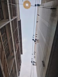 Low angle view of street light against buildings