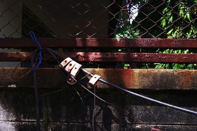 View of chainlink fence against bridge