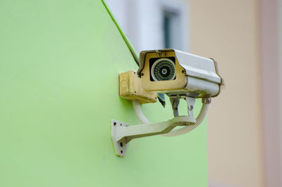 Close-up of telephone booth against wall