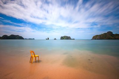 View of beach against cloudy sky