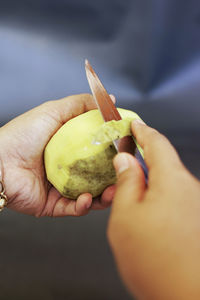 Cropped hand of man holding fruit