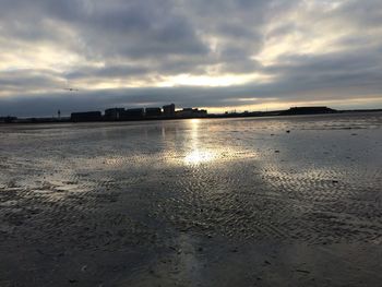 Scenic view of beach against sky during sunset