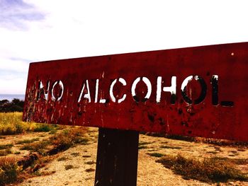 Close-up of road sign on field