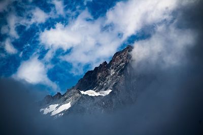 Low angle view of snowcapped mountain against sky