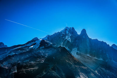 Scenic view of mountains against clear blue sky