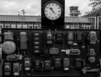 Close-up of clock on bridge against sky