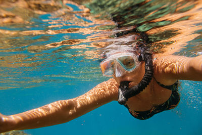 Mature woman snorkeling in sea