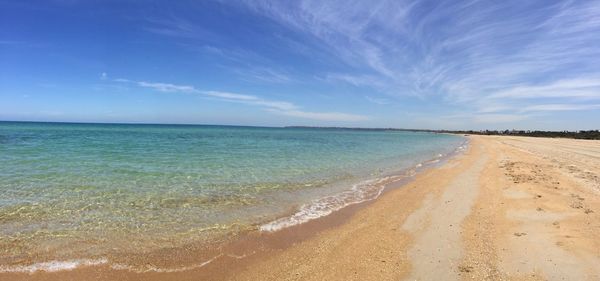 View of beach against cloudy sky
