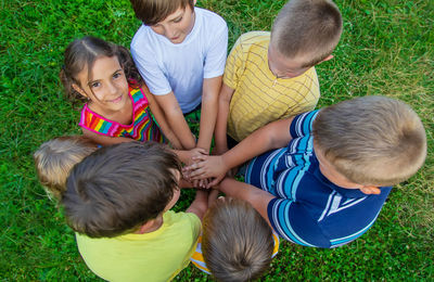 High angle view of boy playing with toys on field