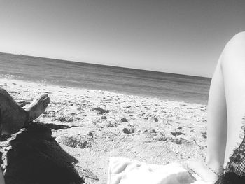 Low section of person standing on beach