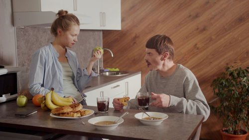 Wife and husband having discussion at kitchen