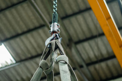 Low angle view of chain hanging on rope