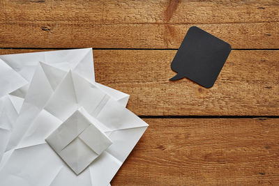 High angle view of white paper on wooden table