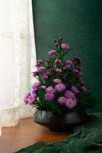 Close-up of pink flower vase on table