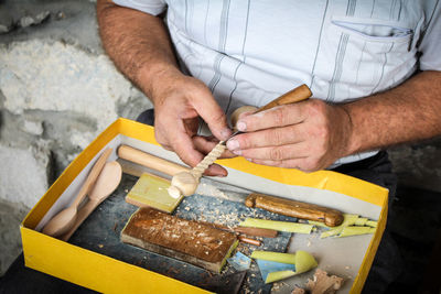 Hands carving wood