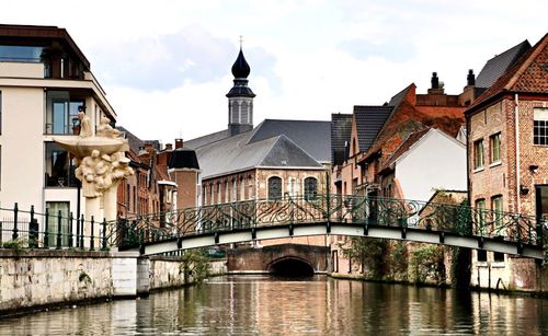 Bridge over river with buildings in background