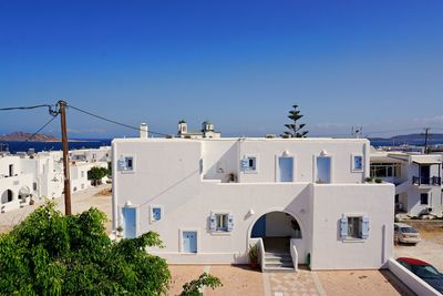 Houses and buildings against blue sky