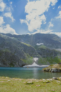 Scenic view of lake and mountains against sky