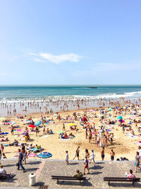 Crowded public beach la grande plage in biarritz, france. atlantic ocean coast, sand beach, summer