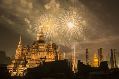 Low angle view of firework display against sky at night