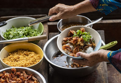 Cropped hand of person preparing food