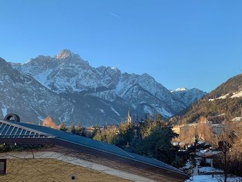 Scenic view of snowcapped mountains against clear blue sky