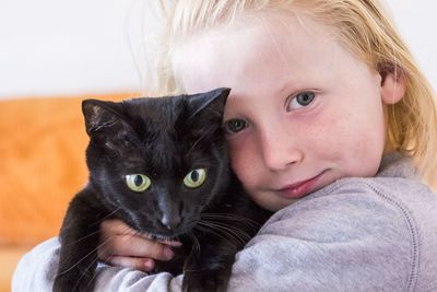 Portrait of cute girl with cat