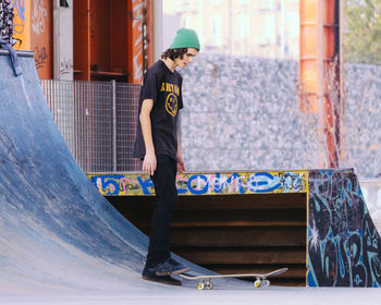 Full length of man standing on skateboard