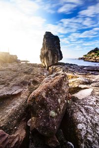 Close-up of rocks on beach against sky