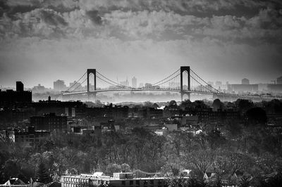 View of suspension bridge against cloudy sky